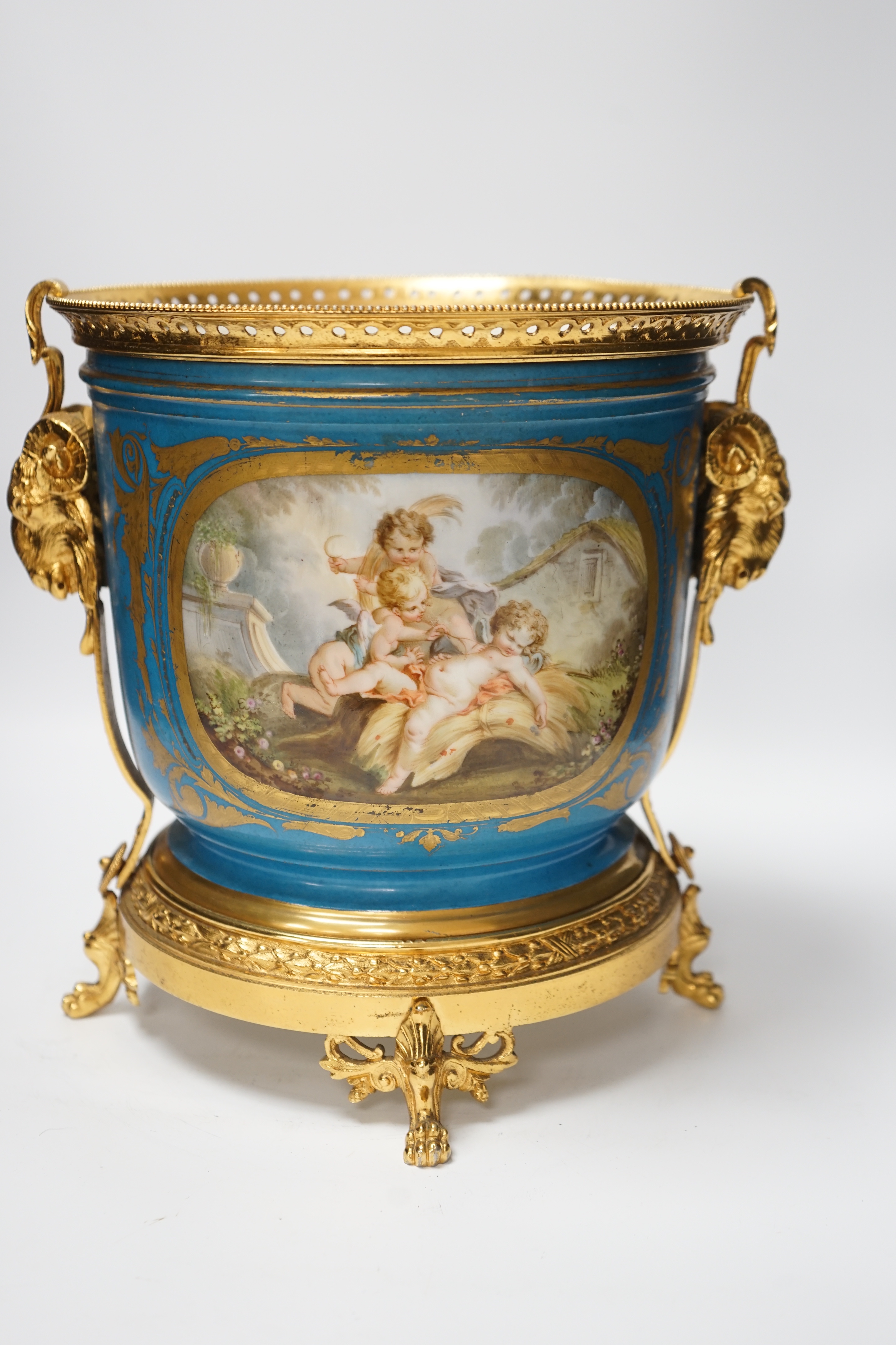 A late 19th century Sevres style jardiniere, turquoise ground with gilt rams head metal mounts, 28cm high